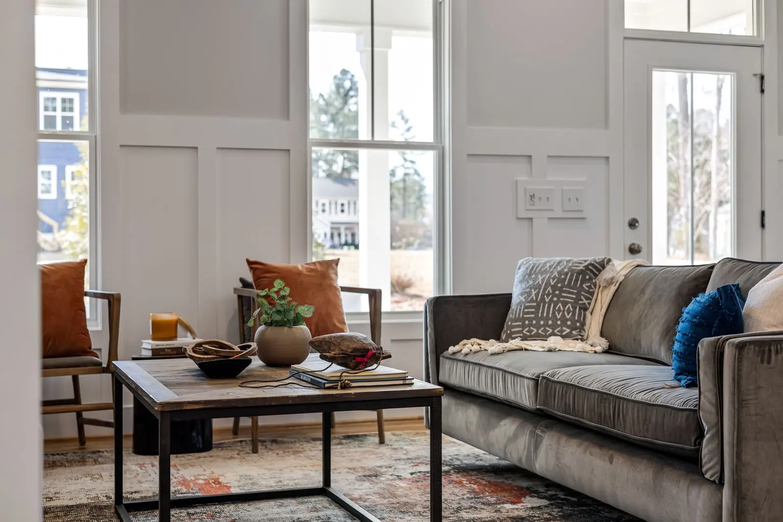Illustrative living room with tall windows and a sofa